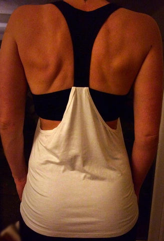 white and black ladies gym vest with racer back detail and attached bra top.
